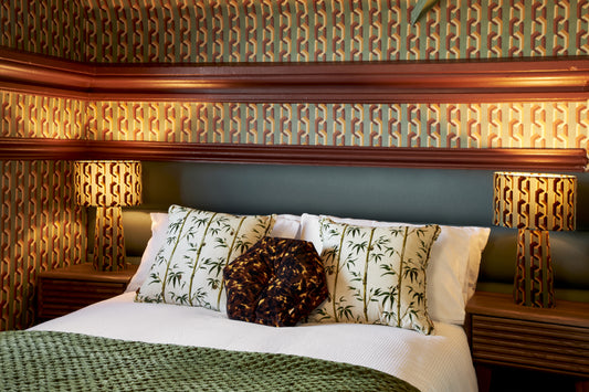 Whinnie Williams Interior Design Service featuring a retro midcentury geometric room. With wallpaper, velvet cushions and a velvet lamp. A very cool 70's style design